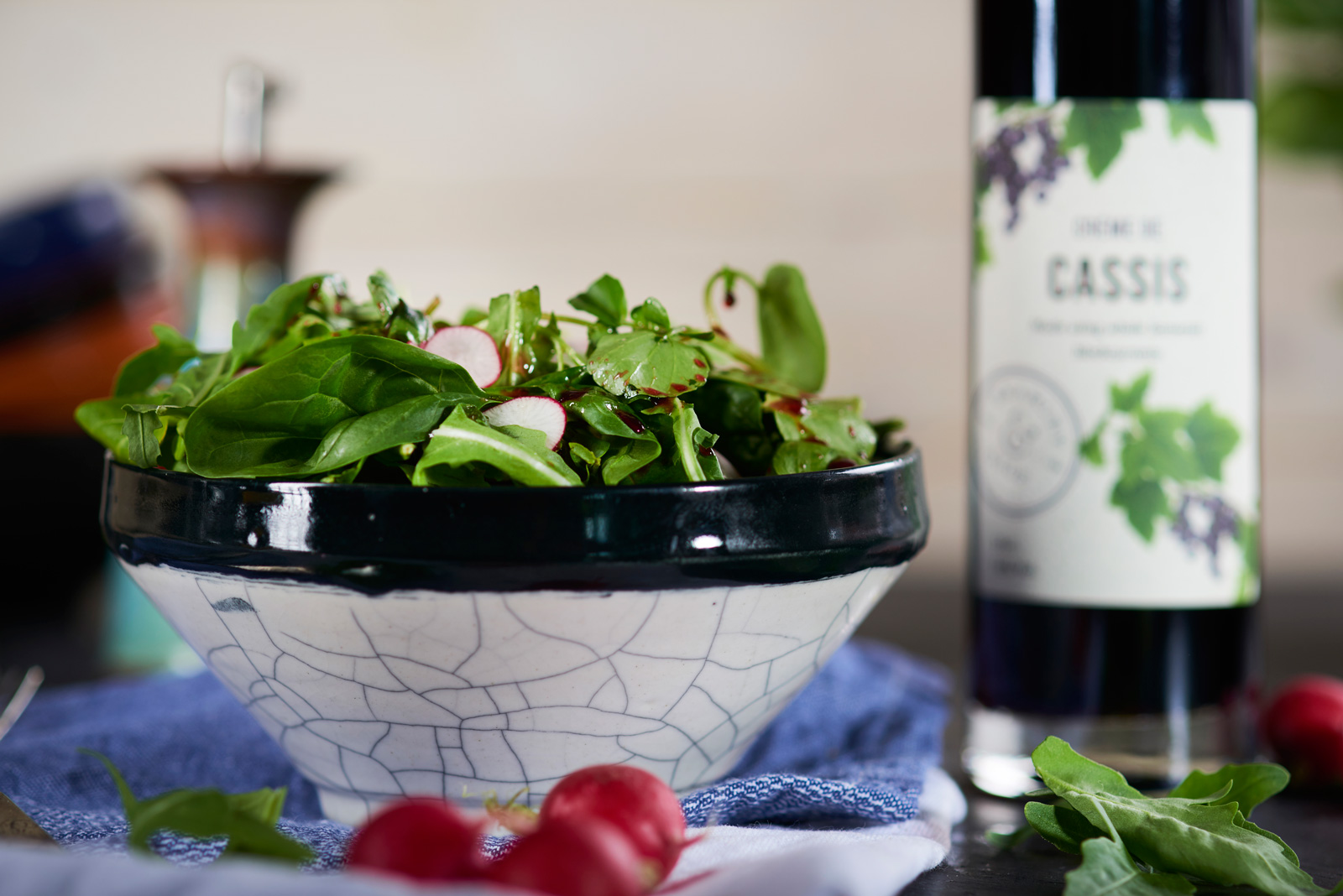 Bowl of salad tossed in 6 O' Clock homemade salad dressing
